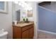Bathroom vanity featuring granite countertops, wood cabinetry, and neutral walls at 3185 Pequod Pl, Kissimmee, FL 34746