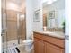 Bathroom featuring a glass-enclosed shower, granite countertop, and wood vanity at 3185 Pequod Pl, Kissimmee, FL 34746