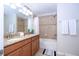 Bathroom featuring double sink, granite countertops, decorative tile, and shower-tub combination at 3185 Pequod Pl, Kissimmee, FL 34746