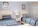 Comfortable bedroom featuring twin beds, bedside lamps and decorative framed artwork at 3185 Pequod Pl, Kissimmee, FL 34746