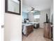 Inviting bedroom featuring two twin beds with ceiling fan, light blue accent wall and carpet flooring at 3185 Pequod Pl, Kissimmee, FL 34746