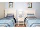 Bedroom featuring twin beds, bedside tables, lamps and decorative artwork at 3185 Pequod Pl, Kissimmee, FL 34746