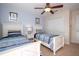 Bright bedroom with twin beds, ceiling fan, and ample natural light at 3185 Pequod Pl, Kissimmee, FL 34746