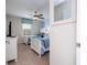 Bedroom with two twin beds, complemented by a ceiling fan and window with floral valance at 3185 Pequod Pl, Kissimmee, FL 34746