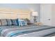 Comfortable bedroom featuring a large bed with stylish blue and gray bedding and a classic white nightstand at 3185 Pequod Pl, Kissimmee, FL 34746