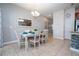 Bright dining area with a chandelier, seating for six, and a view into the modern kitchen at 3185 Pequod Pl, Kissimmee, FL 34746