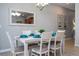 Dining area with a white table, seating for six, and a view into the kitchen at 3185 Pequod Pl, Kissimmee, FL 34746