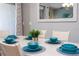 Dining table set with turquoise dishes, perfect for Gathering meals or entertaining guests at 3185 Pequod Pl, Kissimmee, FL 34746