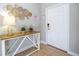Tiled hallway with decor table and decorative wall art near the front door at 3185 Pequod Pl, Kissimmee, FL 34746