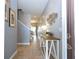 View of the tiled hallway with a decorative table, leading towards the dining area at 3185 Pequod Pl, Kissimmee, FL 34746