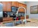 Close-up of kitchen featuring granite countertops, stainless steel appliances, and ample cabinet space at 3185 Pequod Pl, Kissimmee, FL 34746