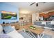 Open-concept living room with a large TV, comfortable seating, and adjacent dining area, creating a welcoming space at 3185 Pequod Pl, Kissimmee, FL 34746