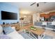 Open-concept living room with a large TV, comfortable seating, and adjacent dining area, creating a welcoming space at 3185 Pequod Pl, Kissimmee, FL 34746