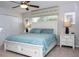 Comfortable bedroom with a ceiling fan, plush bed, and stylish decor at 3185 Pequod Pl, Kissimmee, FL 34746