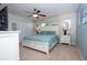 Serene bedroom featuring a plush bed, ceiling fan, and ample natural light at 3185 Pequod Pl, Kissimmee, FL 34746