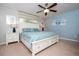 Spacious bedroom offering a comfortable bed, modern ceiling fan, and calming blue accents at 3185 Pequod Pl, Kissimmee, FL 34746