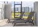 Relaxing screened patio with two lounge chairs overlooking a pond and neighboring building at 3185 Pequod Pl, Kissimmee, FL 34746