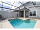 Backyard enclosed pool area with a sparkling swimming pool, lounge chairs and covered patio, perfect for relaxation at 3185 Pequod Pl, Kissimmee, FL 34746