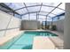 Backyard enclosed pool area with a sparkling swimming pool, lounge chairs and covered patio, perfect for relaxation at 3185 Pequod Pl, Kissimmee, FL 34746