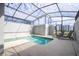 Enclosed pool area with a sparkling swimming pool, lounge chairs, and a view of the modern building, perfect for relaxation at 3185 Pequod Pl, Kissimmee, FL 34746