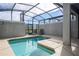Enclosed pool area with a sparkling swimming pool, lounge chairs, and a view of the modern building, perfect for relaxation at 3185 Pequod Pl, Kissimmee, FL 34746