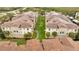 Aerial view of well-maintained condos with lush landscaping and orderly parking at 3301 Whitestone Cir # 204, Kissimmee, FL 34741