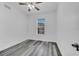Clean bedroom features wood-look floors, a ceiling fan, and a bright window at 3301 Whitestone Cir # 204, Kissimmee, FL 34741