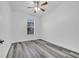 This bedroom features light gray wood-look flooring and a ceiling fan at 3301 Whitestone Cir # 204, Kissimmee, FL 34741