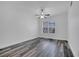 Well-lit bedroom with gray wood floors and a ceiling fan at 3301 Whitestone Cir # 204, Kissimmee, FL 34741
