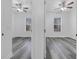 Wood-look floors in bedrooms with ample natural light and ceiling fans at 3301 Whitestone Cir # 204, Kissimmee, FL 34741