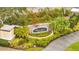 Elegant Flora Ridge Condominiums entrance sign surrounded by lush landscaping and flowering bushes at 3301 Whitestone Cir # 204, Kissimmee, FL 34741