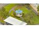 Overhead view of a charming community gazebo with a blue roof, surrounded by manicured landscaping at 3301 Whitestone Cir # 204, Kissimmee, FL 34741