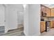 Hallway with wood-look floors leading into the kitchen with stainless steel appliances at 3301 Whitestone Cir # 204, Kissimmee, FL 34741