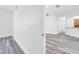 Bright hallway with gray wood floors leading into a spacious open-concept layout at 3301 Whitestone Cir # 204, Kissimmee, FL 34741