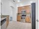 Well-lit kitchen features stainless steel appliances, granite countertops, and light wood cabinetry at 3301 Whitestone Cir # 204, Kissimmee, FL 34741