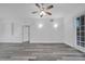 Living room featuring vinyl flooring, ceiling fan, and modern lighting fixtures at 3301 Whitestone Cir # 204, Kissimmee, FL 34741