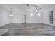 Open floor plan with vinyl flooring, ceiling fan, and modern lighting fixtures at 3301 Whitestone Cir # 204, Kissimmee, FL 34741