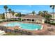 Community pool features a covered area and lounge chairs with plenty of palm trees at 3301 Whitestone Cir # 204, Kissimmee, FL 34741