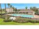 Inviting community pool with lounge chairs and covered seating area surrounded by lush landscaping at 3301 Whitestone Cir # 204, Kissimmee, FL 34741