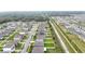 Aerial view of a neighborhood featuring well-maintained homes, green lawns, and a community drainage canal at 3493 Lazy River Ter, Sanford, FL 32771