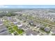 Expansive aerial view of a residential community featuring uniform housing, streets, landscaping, and natural surroundings at 3493 Lazy River Ter, Sanford, FL 32771