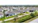 View of a home's backyard with green grass, white fence, and a view of the community drainage canal at 3493 Lazy River Ter, Sanford, FL 32771