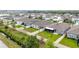 A view of the fenced backyards in a neighborhood featuring well-maintained lawns and varied home designs at 3493 Lazy River Ter, Sanford, FL 32771