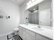 Bathroom featuring double vanity, tiled floors and shower with gray shower curtain at 3493 Lazy River Ter, Sanford, FL 32771