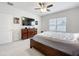 Bright bedroom features a wooden dresser, a ceiling fan, and a large TV at 3493 Lazy River Ter, Sanford, FL 32771