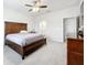 Large bedroom featuring a wooden dresser and access to a private bathroom at 3493 Lazy River Ter, Sanford, FL 32771