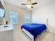 Bright bedroom with carpet, ceiling fan, and two windows at 3493 Lazy River Ter, Sanford, FL 32771