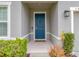 Welcoming front entrance with a stylish blue door and decorative plants at 3493 Lazy River Ter, Sanford, FL 32771
