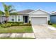 Inviting single-Gathering home featuring a well-maintained lawn and a two-car garage at 3493 Lazy River Ter, Sanford, FL 32771