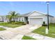 Beautiful curb appeal with a well-kept lawn, mature landscaping, and neutral color scheme at 3493 Lazy River Ter, Sanford, FL 32771
